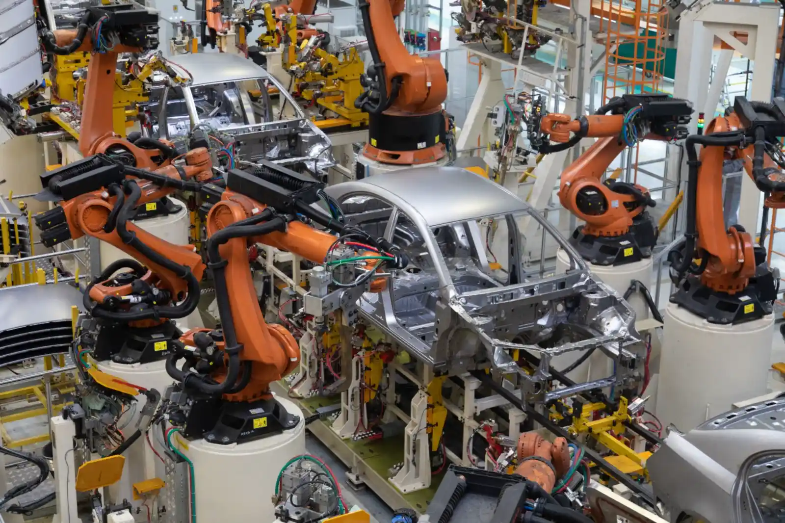Automotive manufacturing floor with robotic weld cells on the body-shop line